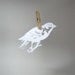 Paper-cut Scherenschnitte silhouette Finch on a Twig in Snow White
