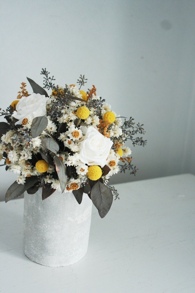 Field harvest. Natural dried flower arrangement in cement vase.