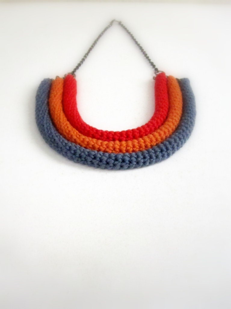 Orbits, crochet bib necklace in red, orange and titanium grey.