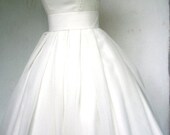 A beautiful ivory 50s inspired dress boat neck, and darling pleated skirt