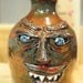 Stoneware Pottery Ugly Face Jug. 6" tall to top of handle.