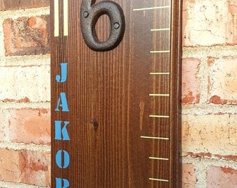 Wooden Growth Chart With A Custom Name And Stripes