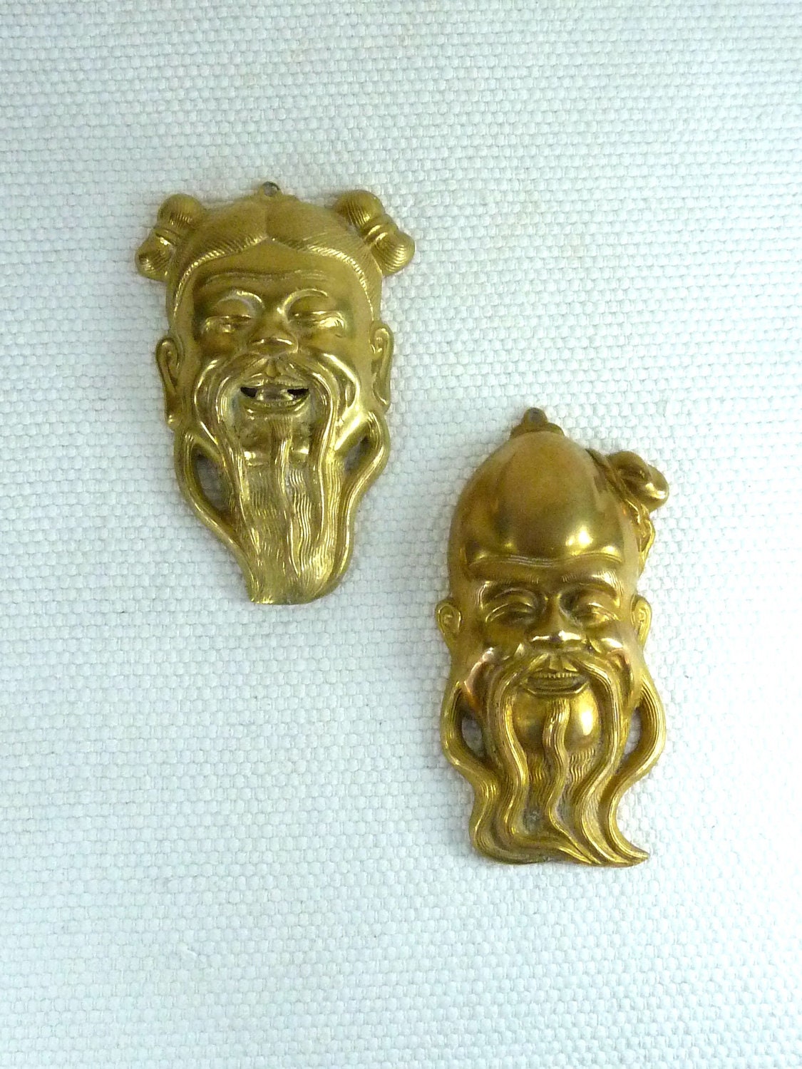 Two Hanging Oriental Brass Faces