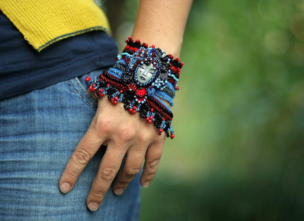 Crochet Cuff with Polymer Clay Face in Black, Red and Blue - ellisaveta