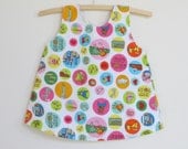 Baby dress, New York pixie pops print, crossover back sundress pinny size 1, Sweet on NYC big city dot fabric, upcycled cot sheet lining,
