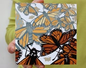Swarm of light and dark monarch butterflies mounted on bamboo