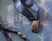 Swirly silver on indigo ribbon