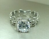 Leaf floral engagement ring with Moissanite center.
