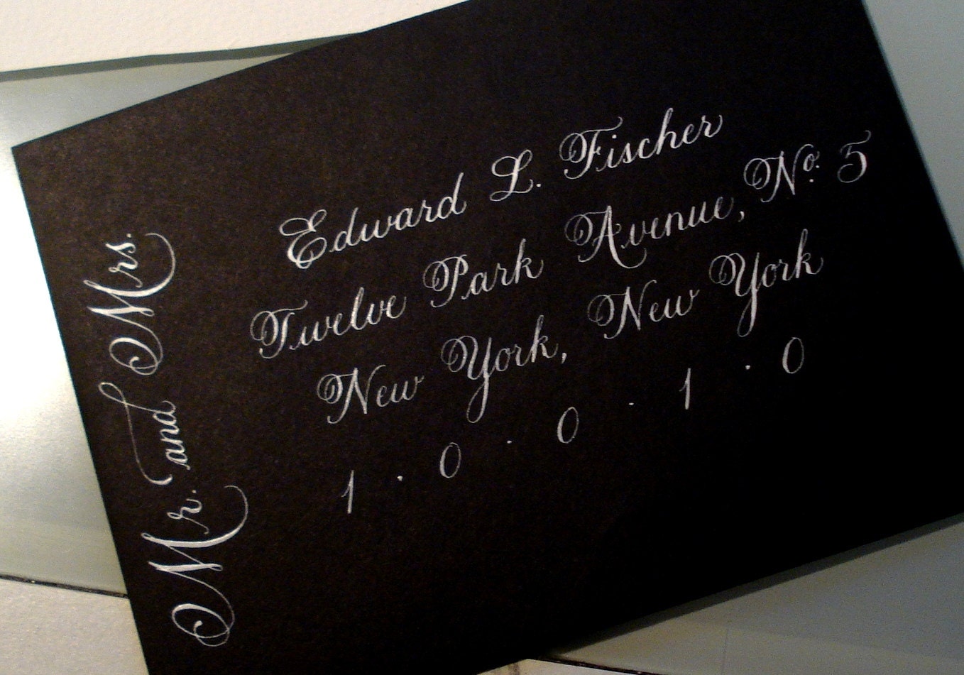 White ink calligraphy on Black envelopes