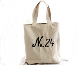As Seen In Romantic Homes, French Market Tote, embroidered with "No. 24". Black and white Paris print lining. Sturdy duck natural canvas.