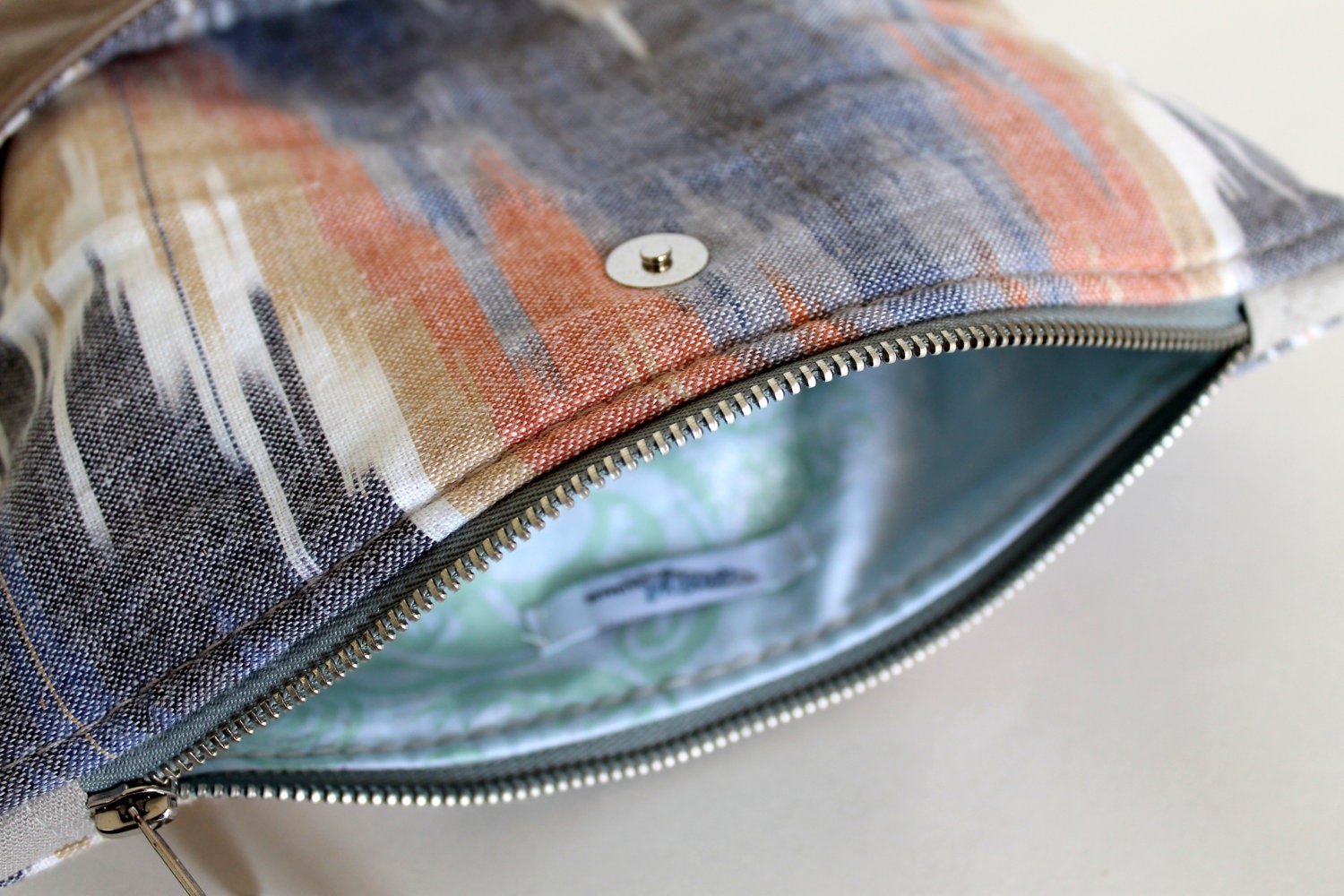 Ikat and leather fold over clutch