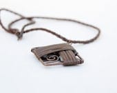 Leather cord necklace with copper wire wrapped pendant....