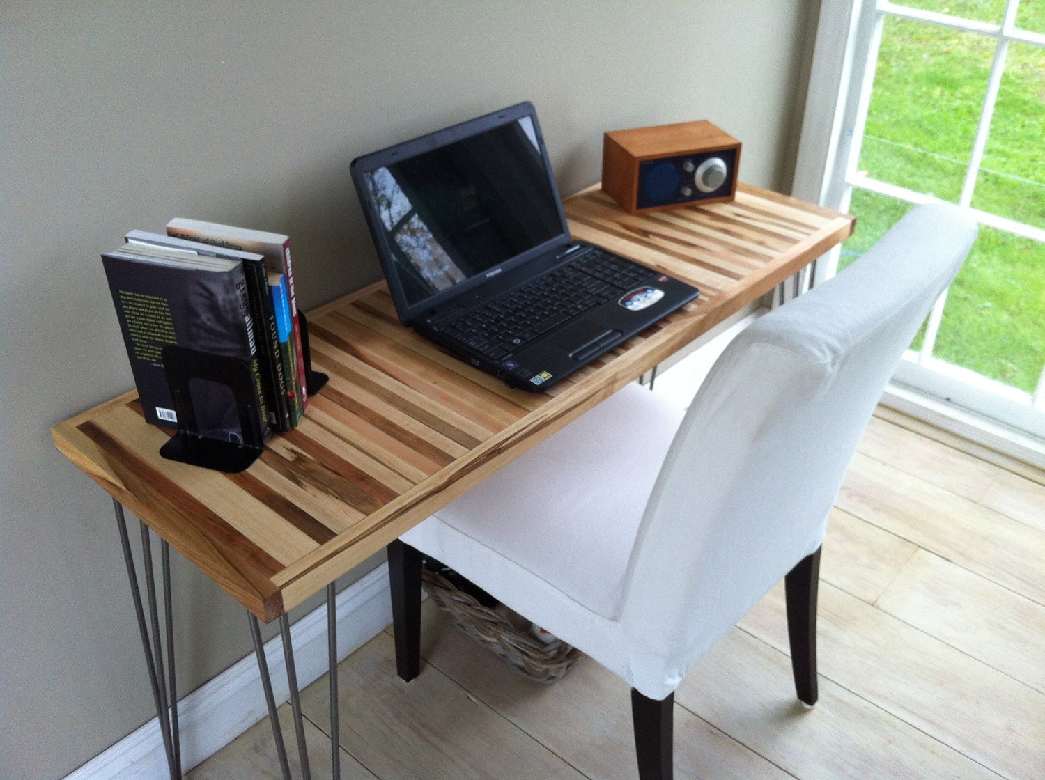 Mid century modern desk featuring wormy maple top and hairpin legs, 18" x 50".