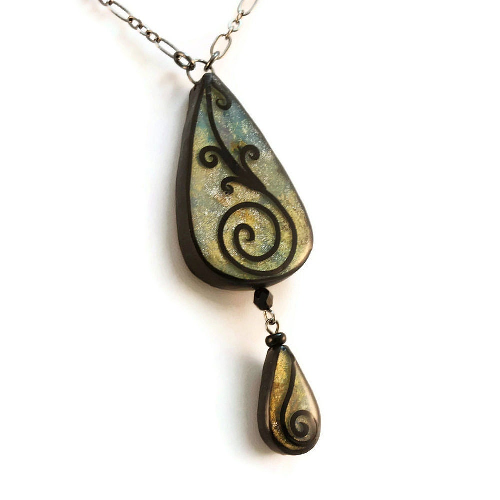 Teardrop necklace in shades of blue and gold with spiral design