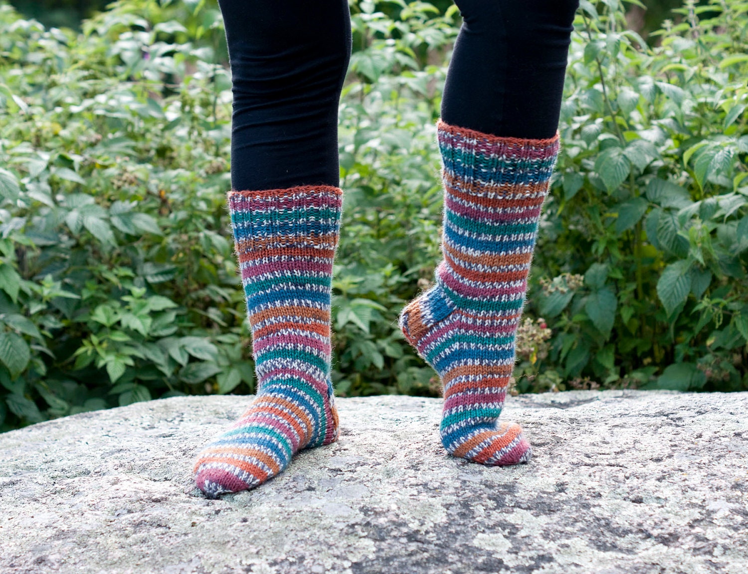 Hand knit socks with stripes in the colors of the pheasant - orange, green, teal, red and gray