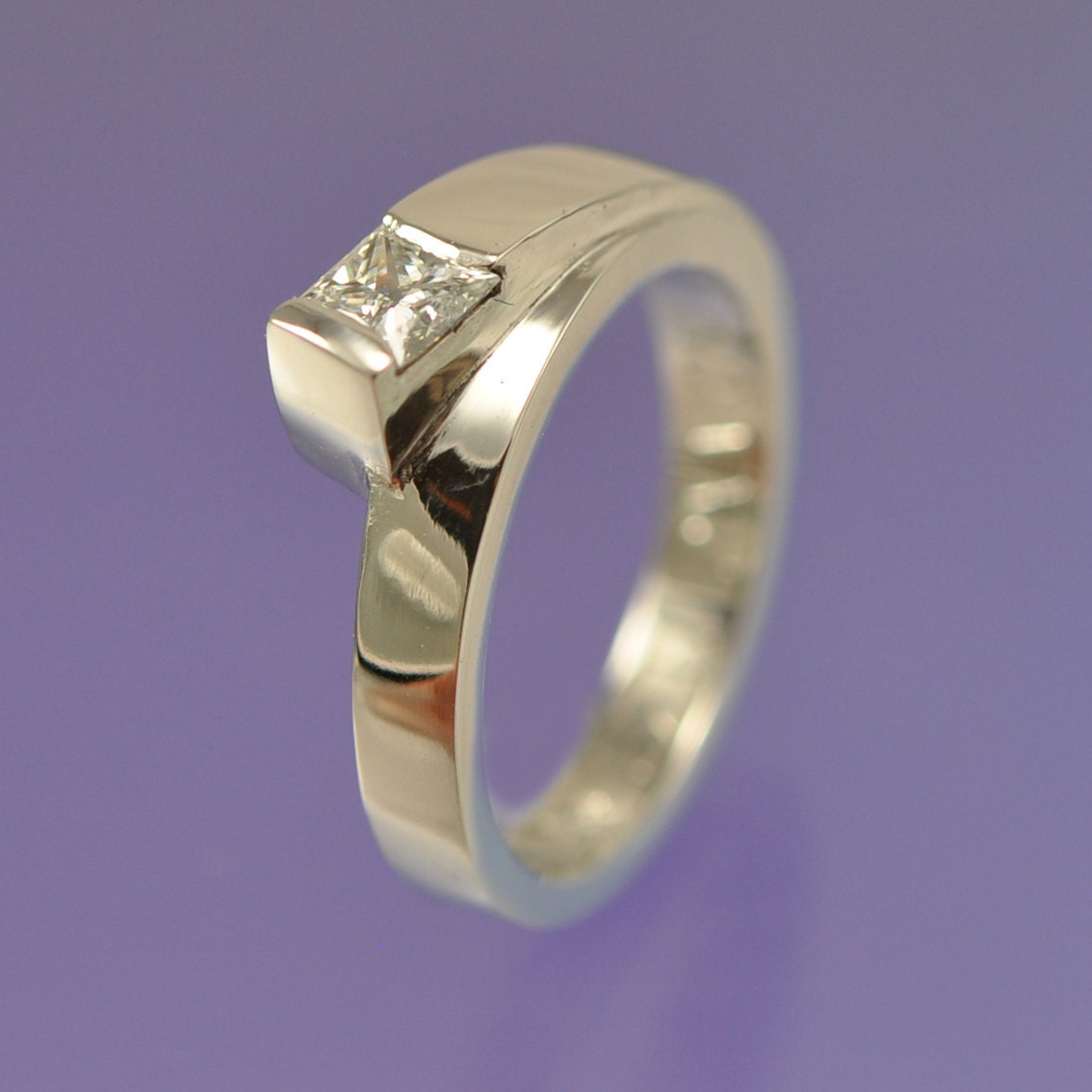A 4mm princess diamond engagement ring (0.40ct) set in 18k white gold.