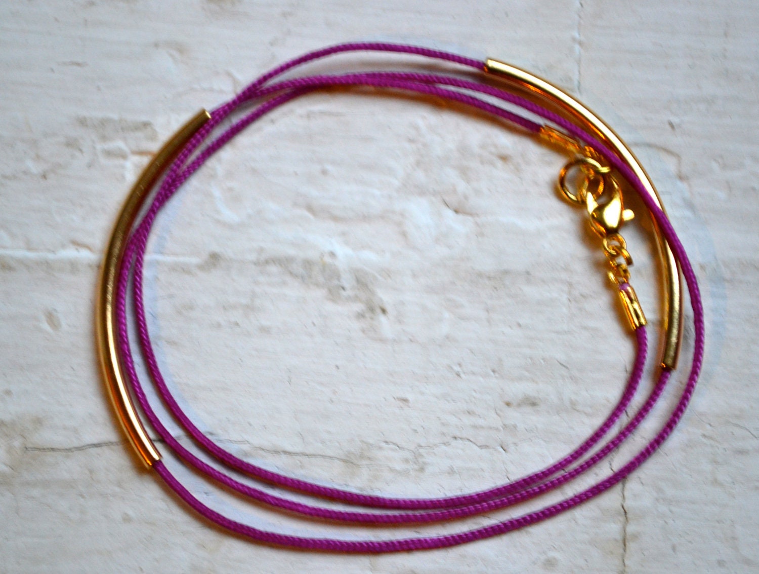 plum purple super skinny nylon triple wrap bracelet with two long gold tube