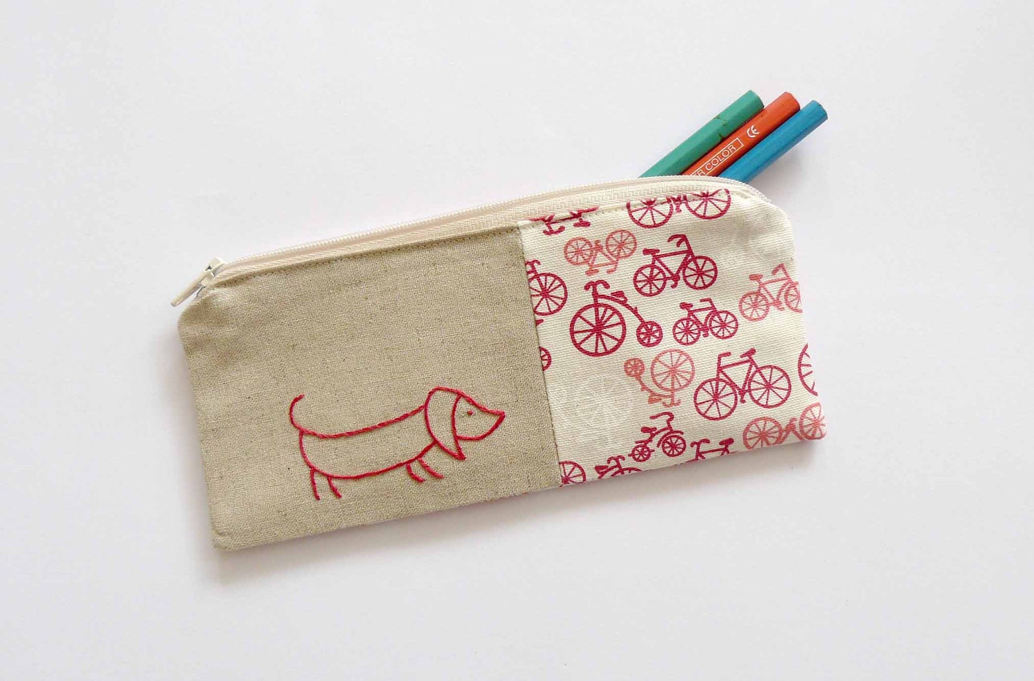 Pink sausage dog with bikes pencil case or zipper pouch. hand embroidery with bicycle fabric