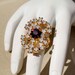 Vintage Sarah Coventry Gold ring with purple and white stones