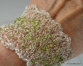 Holli, handmade cuff of silver plated, non tarnish wire, knitted with smooth, semi-precious, peridot saucer beads