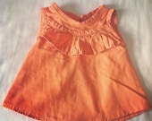 orange ruffle shirt