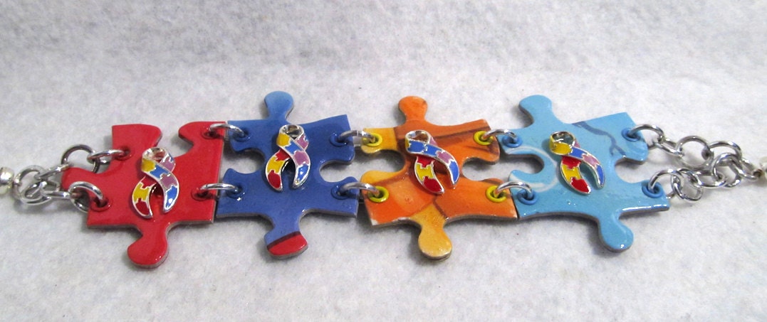 Reversible Autism Awareness Puzzle Bracelet with big yellow, red, light blue, and royal blue puzzle pieces