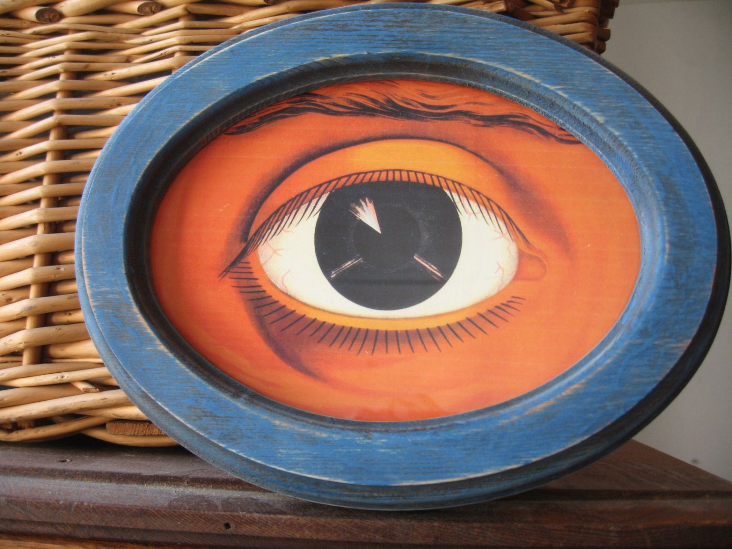 blue antiqued painted wood frame with oculist eye