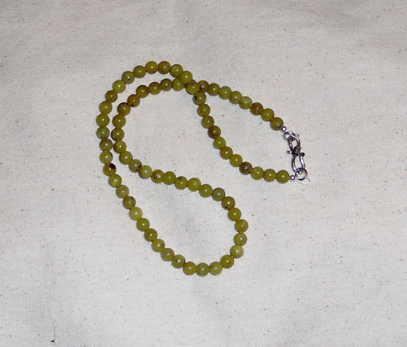 Olive green African jade necklace stone jewelry packaged in a colorful gift bag J569