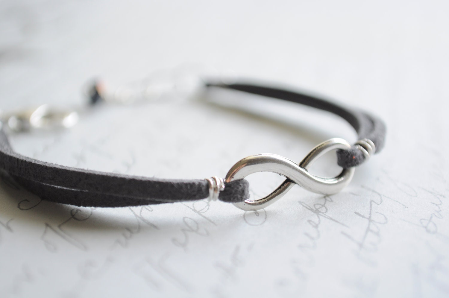 Infinity bracelet-  Charcoal suede cord with silver lobster claw clasp and czech glass
