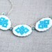 Hand embroidered necklace with three blue Ukrainian ornament in silvertone