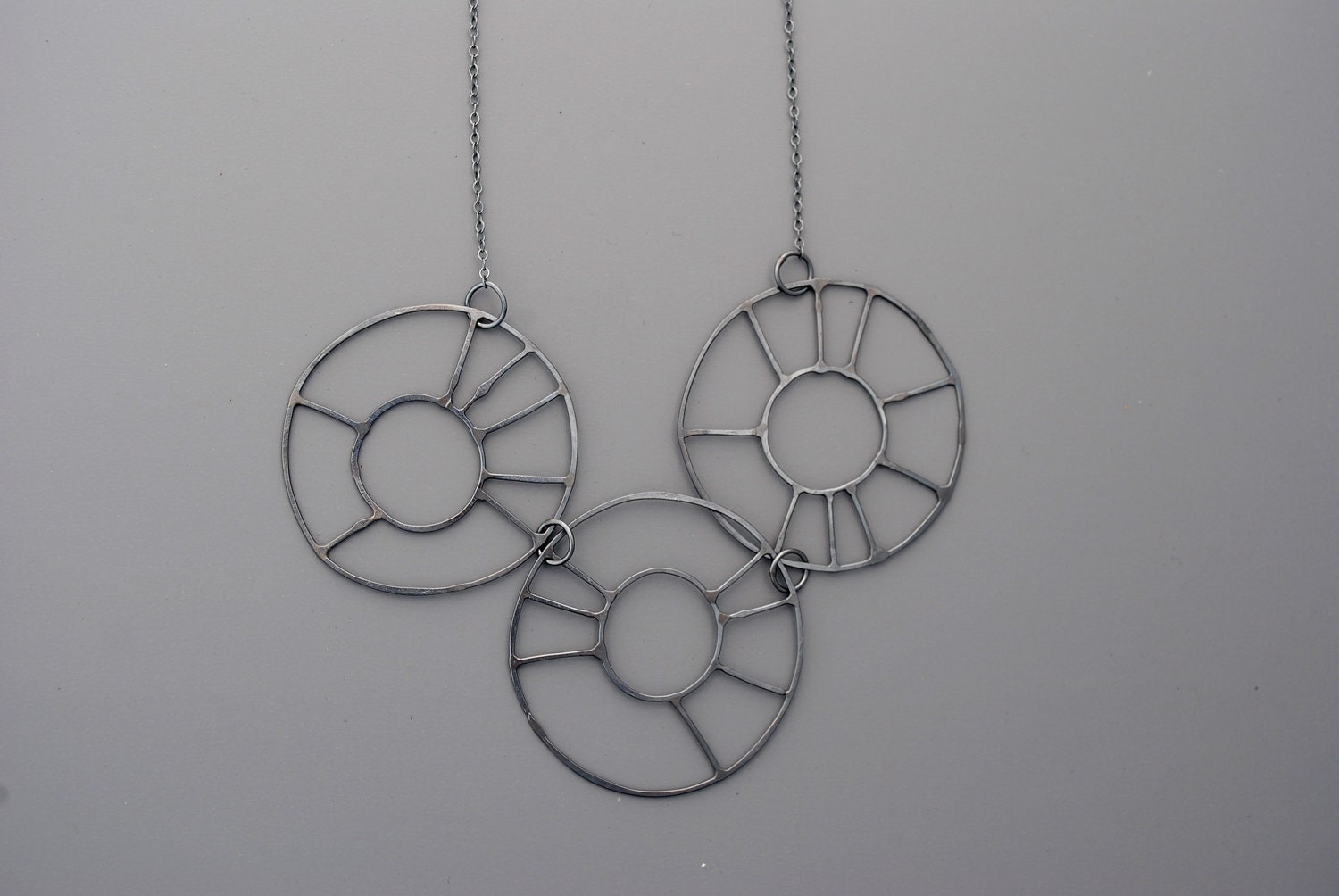 Handmade jewelry. Blackened sterling silver three wheels necklace