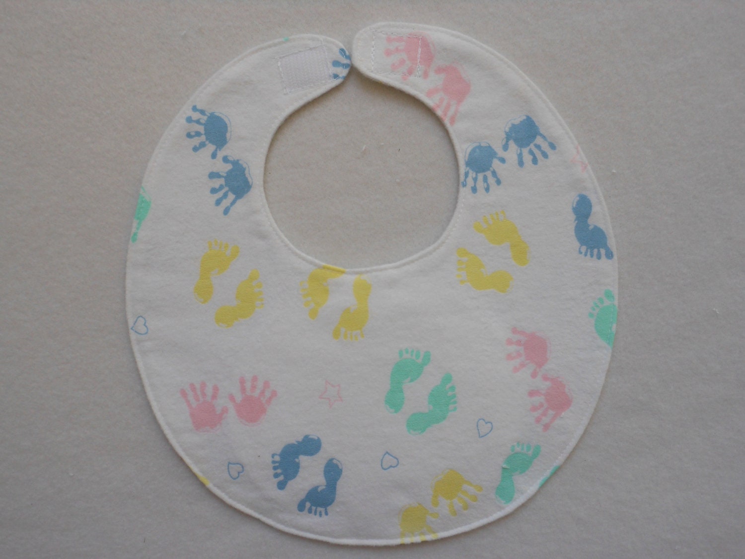 Baby bib, four thick soft layers, reversible,white with baby foot, and hand prints