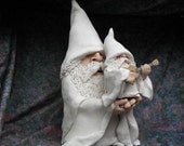 Large White Pottery Wizard holding Smaller Wizard playing guitar