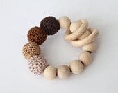 Brown, chocolate, beige teething ring toy with crochet wooden beads. Rattle for baby.