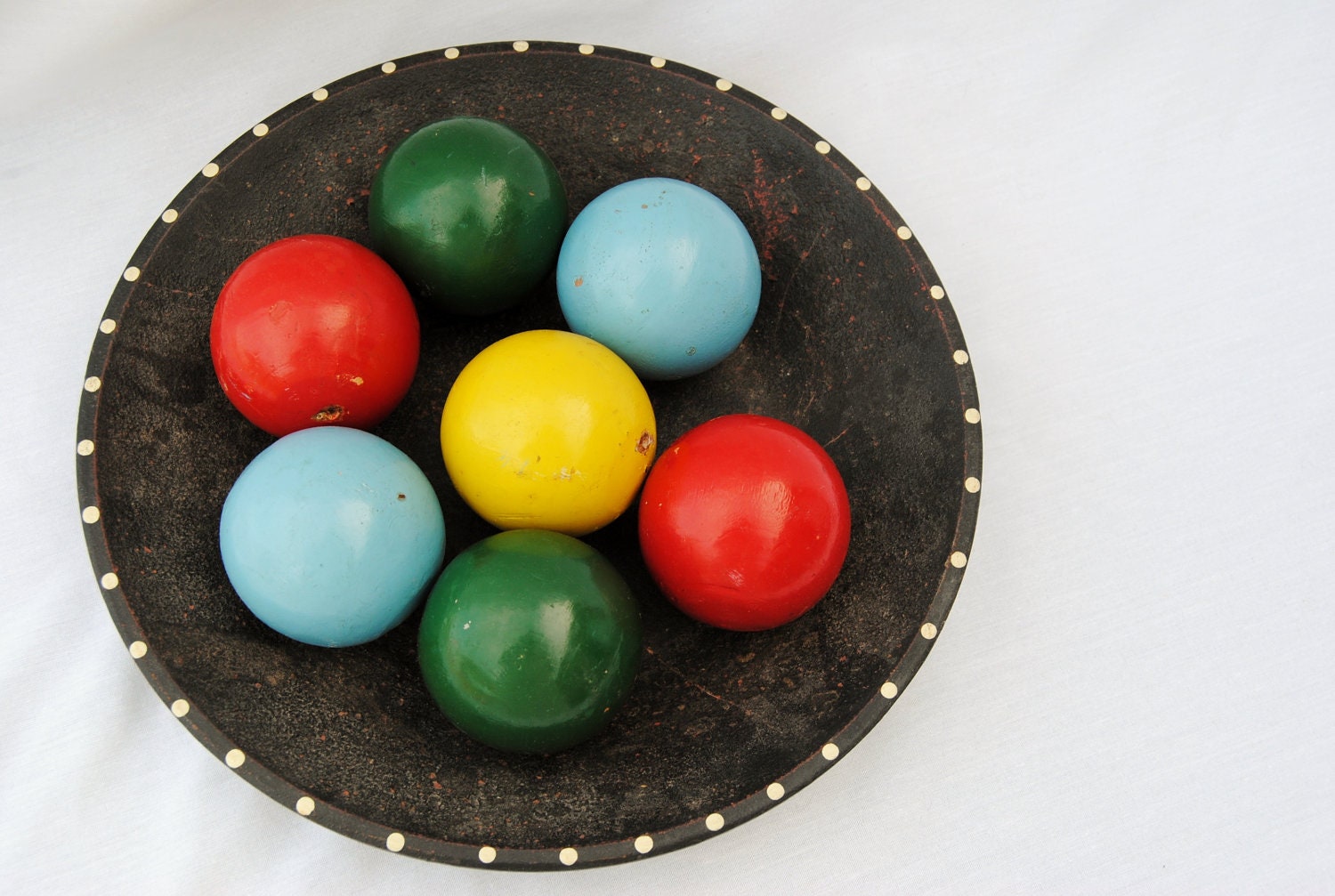 Wooden croquet balls in bowl