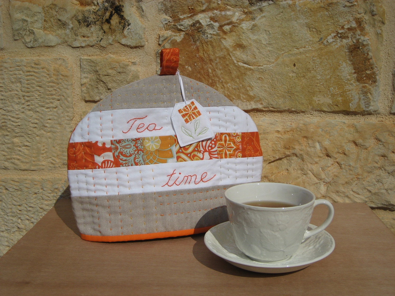 Tea Cosy with a little tea bag, patchwork, embroidery in orange, white and beige