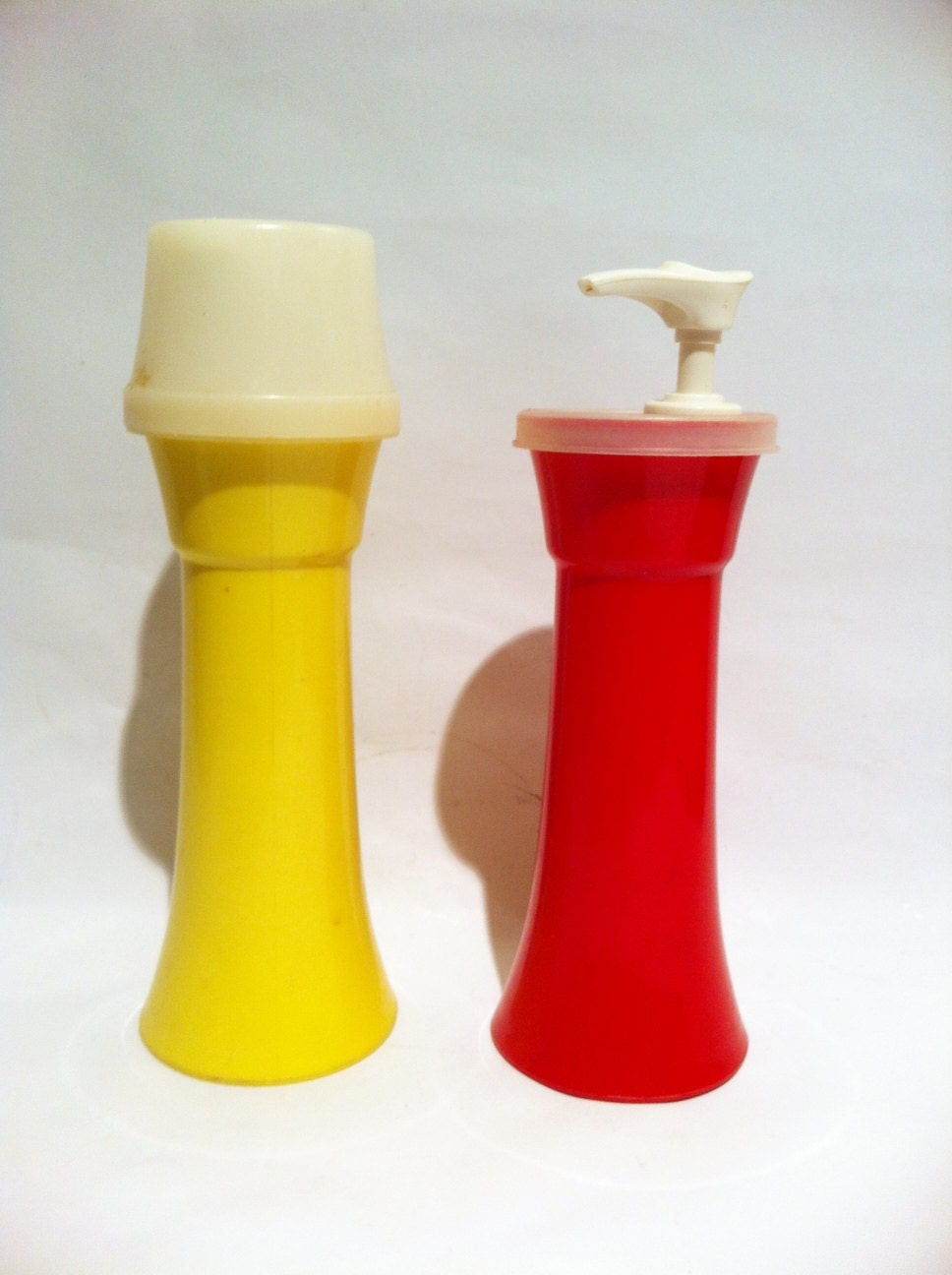 Vintage Tupperare ketchup and mustard dispenser.  Red and yellow.