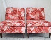 A pair of vintage upholstered slipper chairs in a chinoiserie vintage pink and red cotton fabric