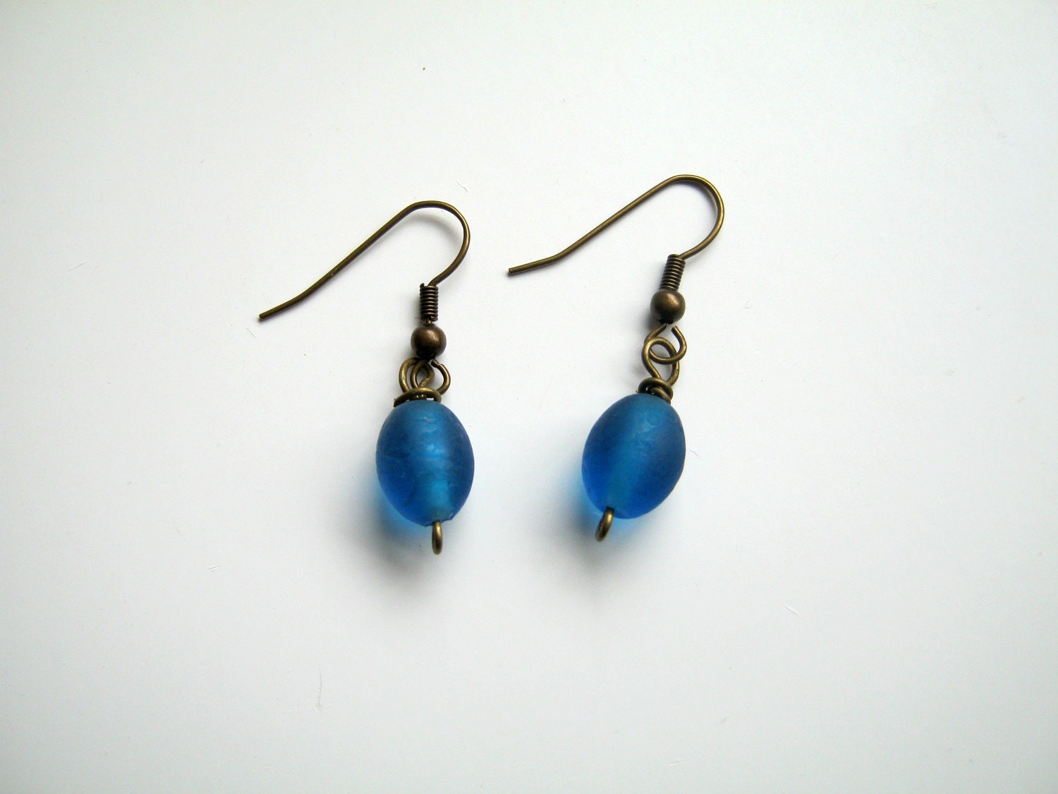 Drop earrings made with peacock blue glass beads and antique bronze wires