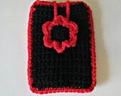Crocheted phone cover in black with a bright red flower and trim