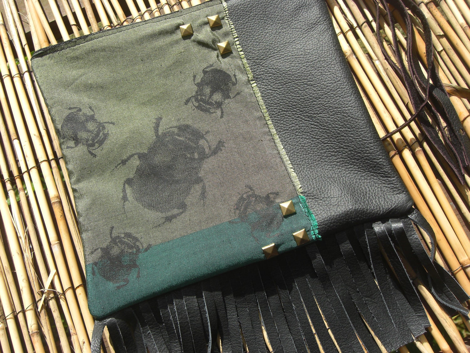 Hand made black leather clutch bag with screen printed scarab beetle design
