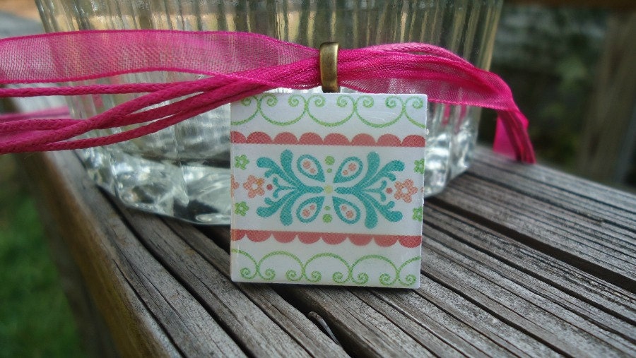 Patterned Necklace with Pretty Flowers Pastel Colors on Wood Tile