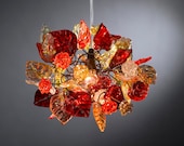 Ceiling light fixture. Red shades of flowers and leaves.
