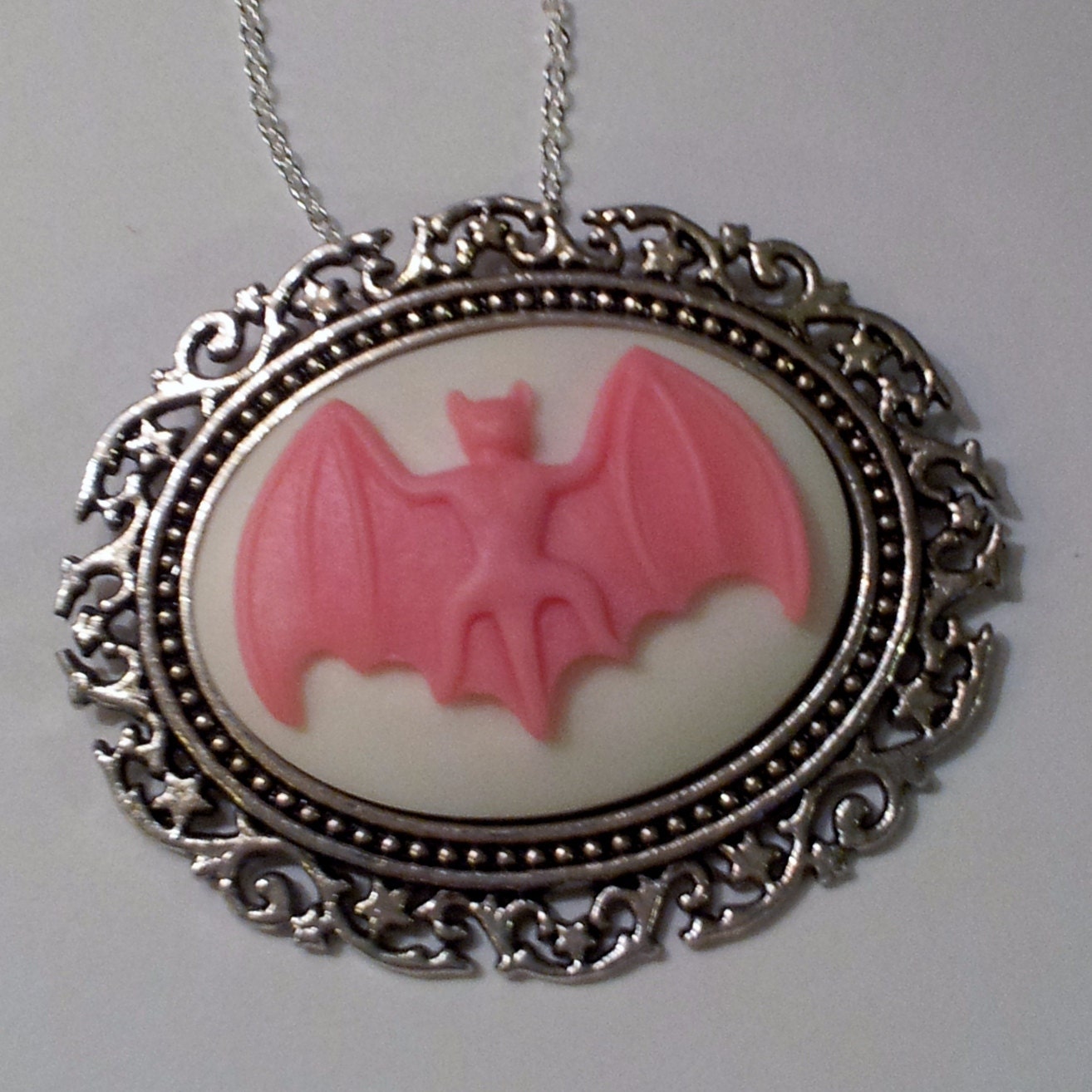 Gothic Vlad the Bat Cameo Pendant on a chain in Pink and White