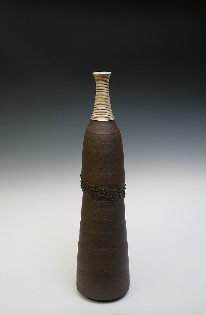 Very Tall Wheel Thrown Black Mountain Clay bottle in bare clay body with glaze on neck