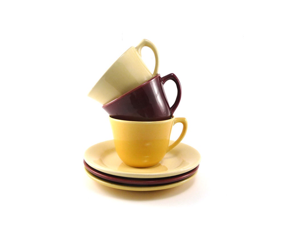 Vintage Bauer cups and saucers in red oxblood honey gold and yellow