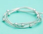 Silver ball bracelet - fluid design wrapping three times around wrist - polished mirror finish with toggle clasp