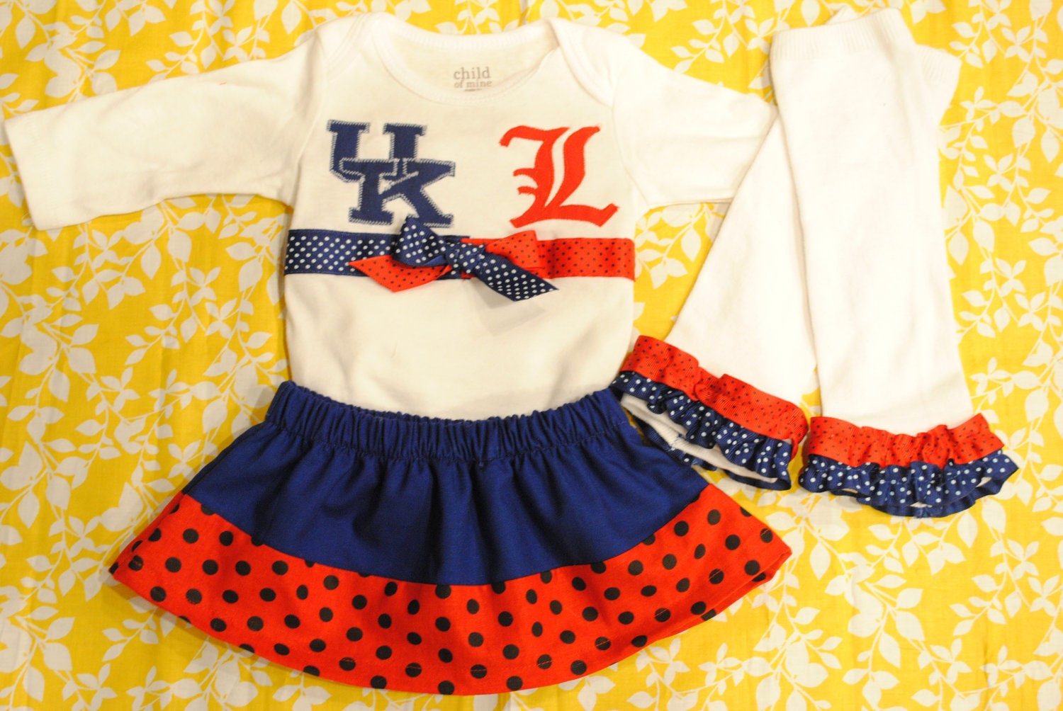 Variety of Teams Available. Kentucky vs. Louisville House Divided Team Outfit Including Onesie, Skirt, legwarmers, and Bow