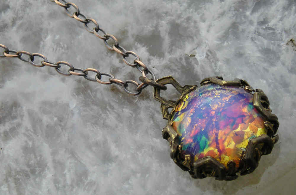 Subtle and magical vintage harlequin glass..old brass filigree wrapped pendant necklace
