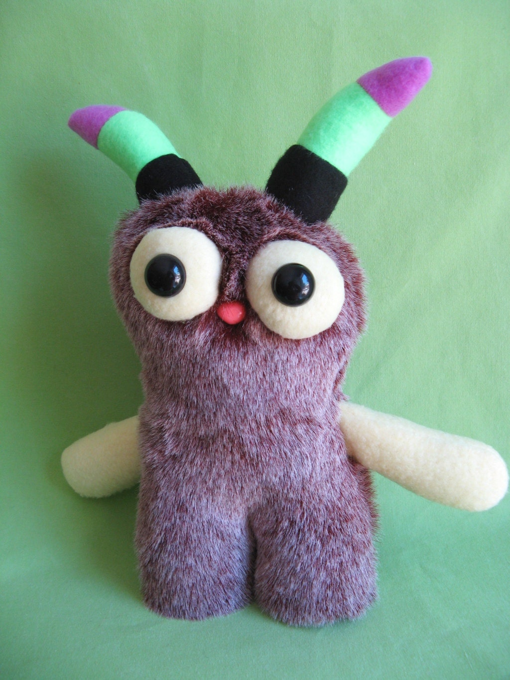 Monster toy stuffed animal plush with striped horns